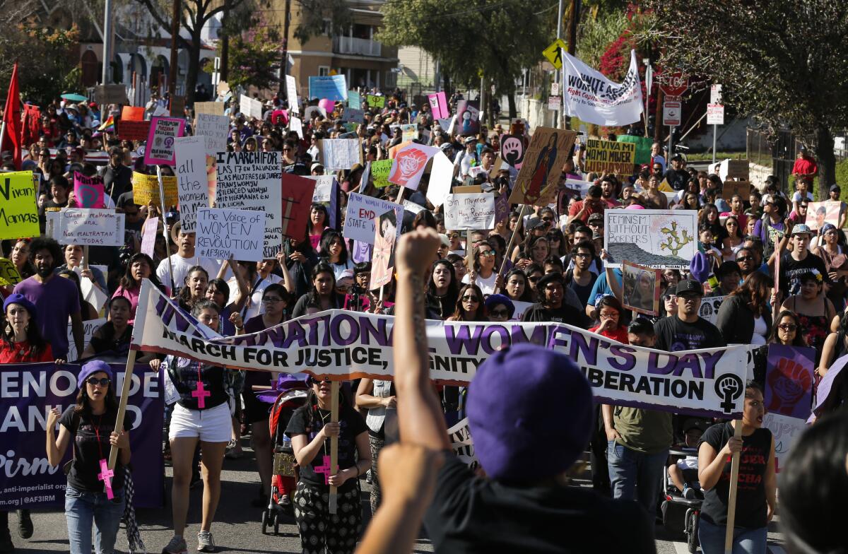 Hundreds of people marched through downtown Los Angeles Sunday afternoon to mark International Women's Day.