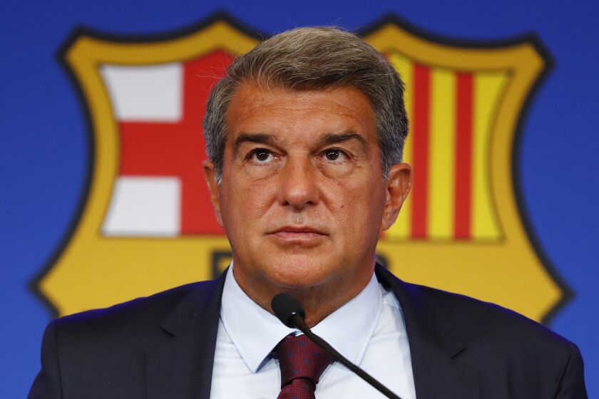 FILE - FC Barcelona club President Joan Laporta pauses during a news conference in Barcelona, Spain, on Aug. 6, 2021. Barcelona won’t be able to reduce its salary burden to acceptable limits for the club until several veteran players finish their contracts, its top financial officer said Thursday, Oct. 6, 2022. (AP Photo/Joan Monfort, File)