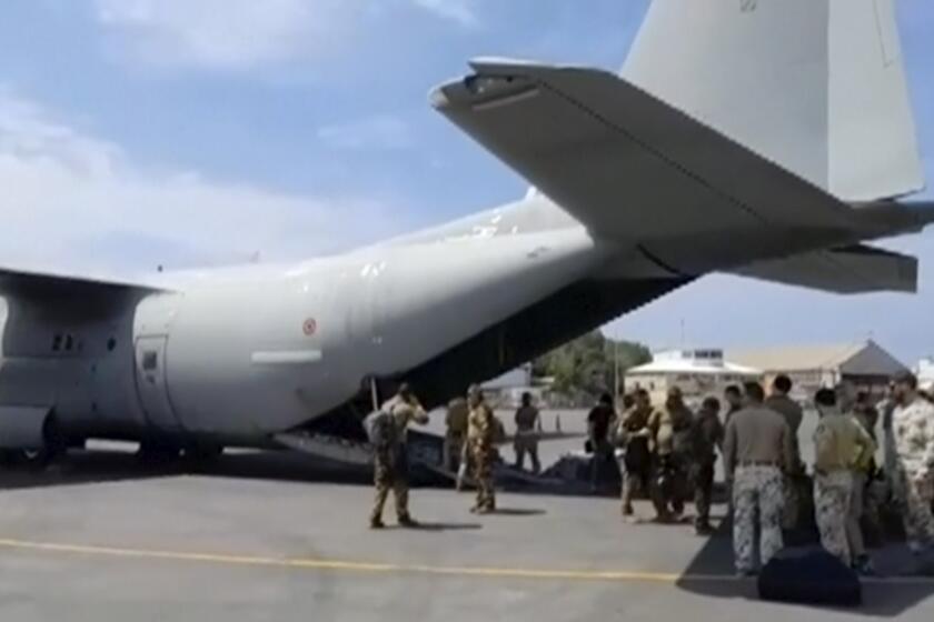 In this image from video provided by the Italian Defense Ministry, military personnel prepare to evacuate people from the airport in Khartoum, Sudan, on Sunday, April 23, 2023. Foreign nationals were flown out of the country, as forces loyal to rival generals battled for control of Africa's third-largest nation for a ninth day amid fading hopes for deescalation. (Italian Defense Ministry via AP)