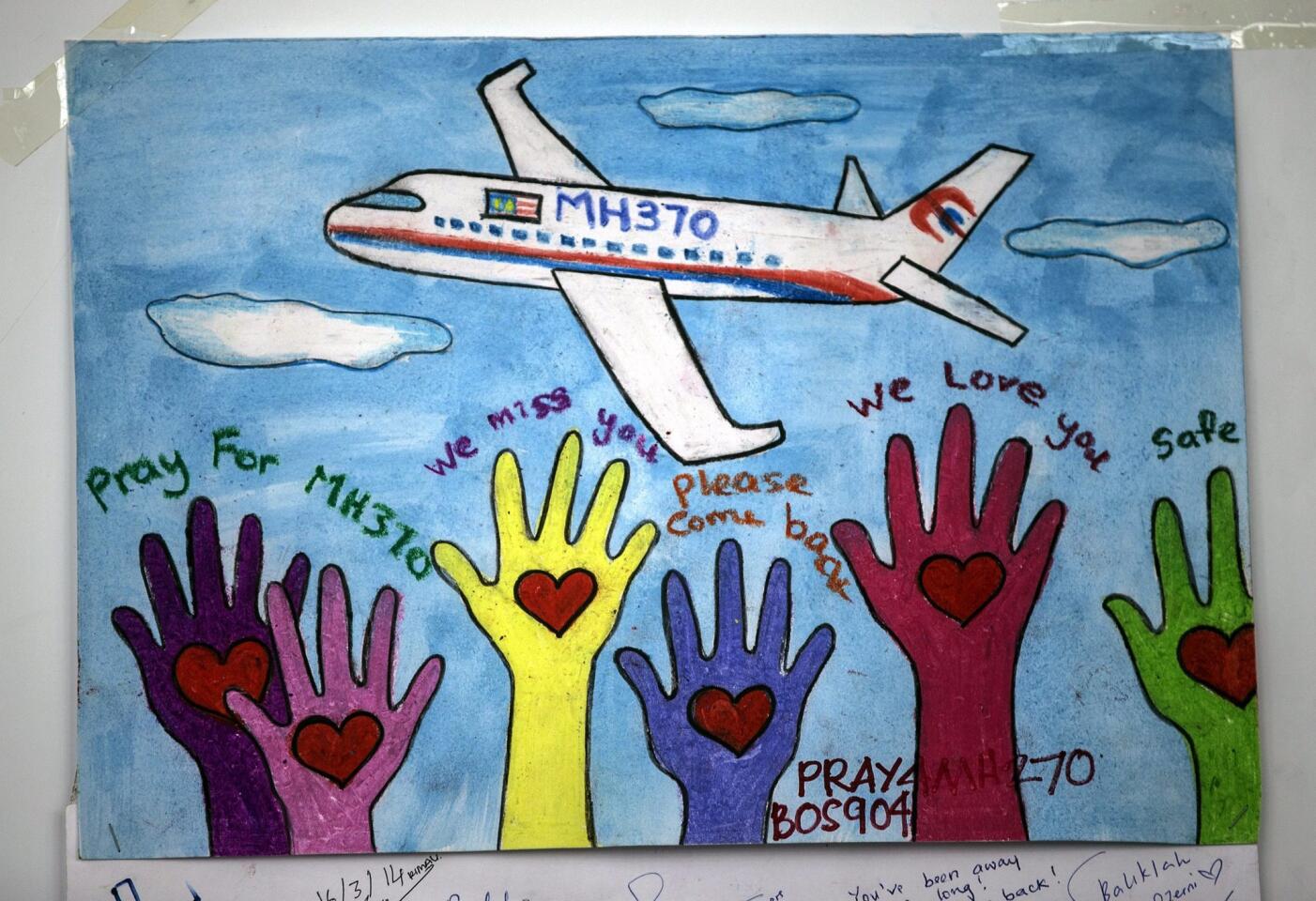 A message of support is displayed at the wall of hope for the missing passengers of the Malaysian Airlines plane at Kuala Lumpur International Airport viewing gallery, Malaysia, 18 March 2014.