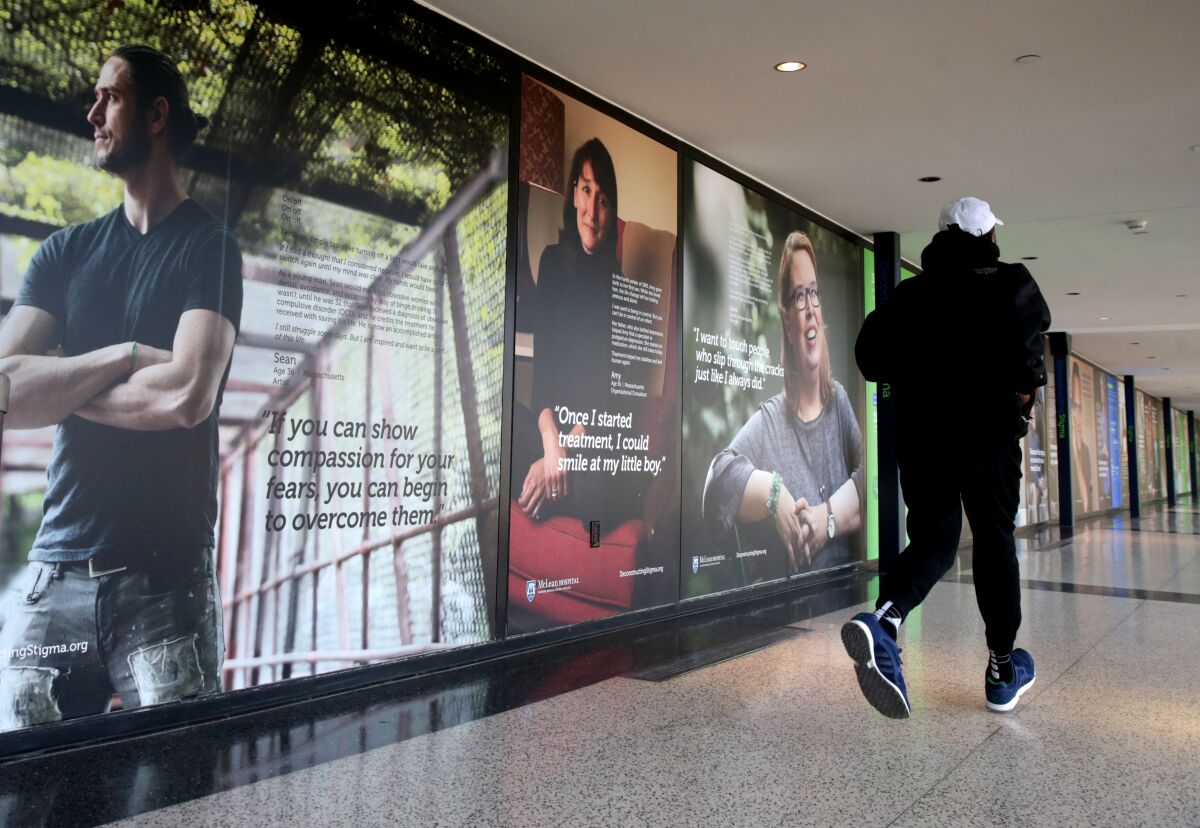A photo exhibit examining mental health issues displayed at an airport