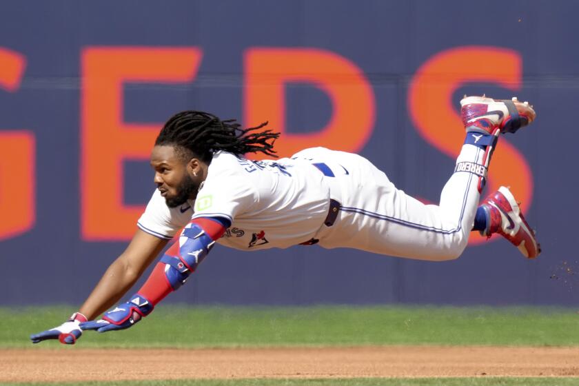Toronto Blue Jays' Vladimir Guerrero Jr. (27) dives to slide safe into second base for a double during the fourth inning of a baseball game against the Tampa Bay Rays, Saturday, May 18, 2024, in Toronto. (Chris Young/The Canadian Press via AP)