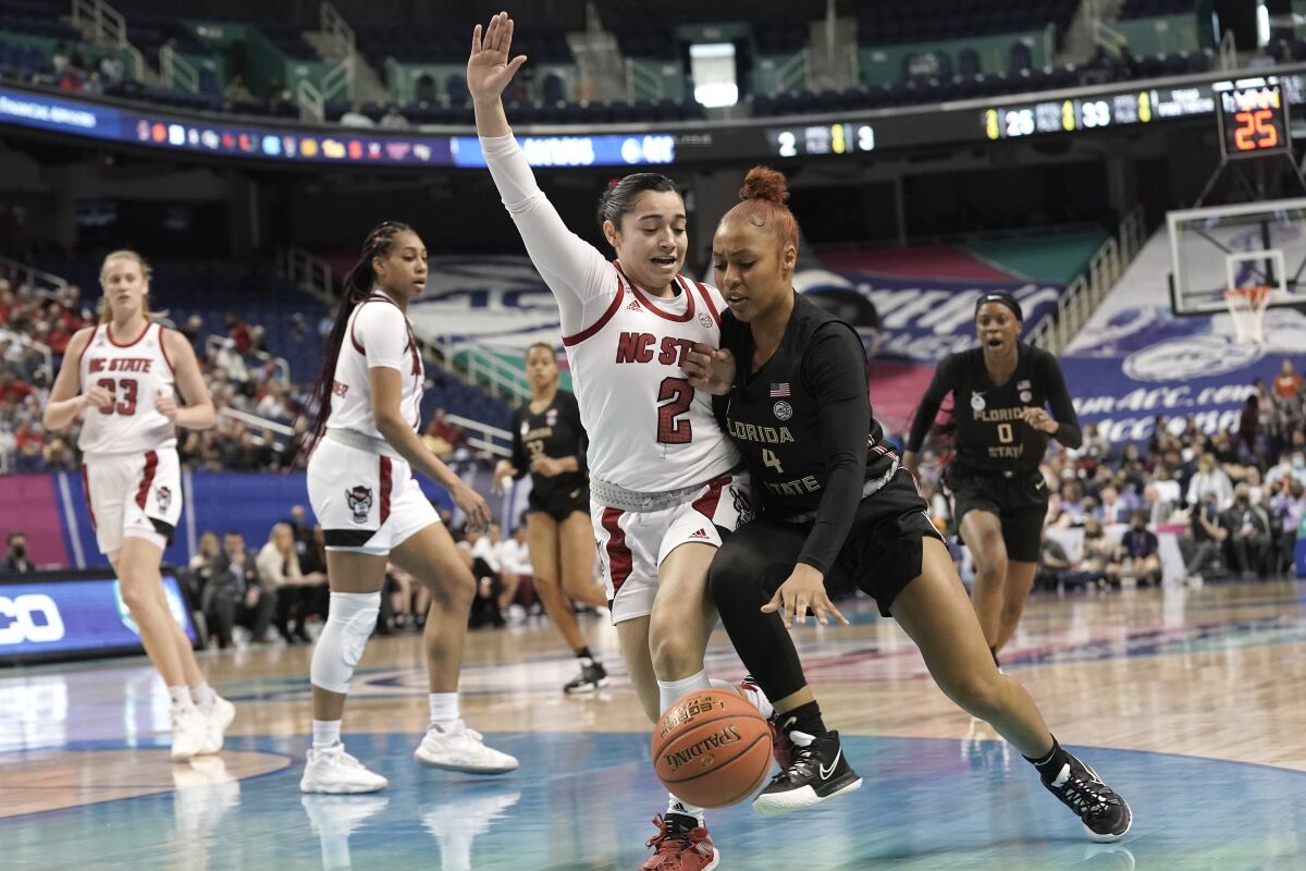 North Carolina State guard Raina Perez (2) defends against Florida State guard Sara Bejedi (4) during the first half of an NCAA college basketball quarterfinal game at the Atlantic Coast Conference women's tournament in Greensboro, N.C., Friday, March 4, 2022. (AP Photo/Gerry Broome)
