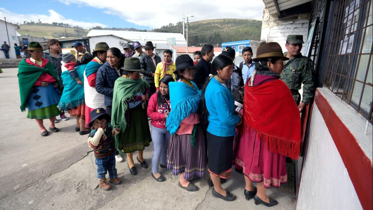 Voters line up to cast ballots in the town of Cangahua, northeast of Quito, Ecuador.