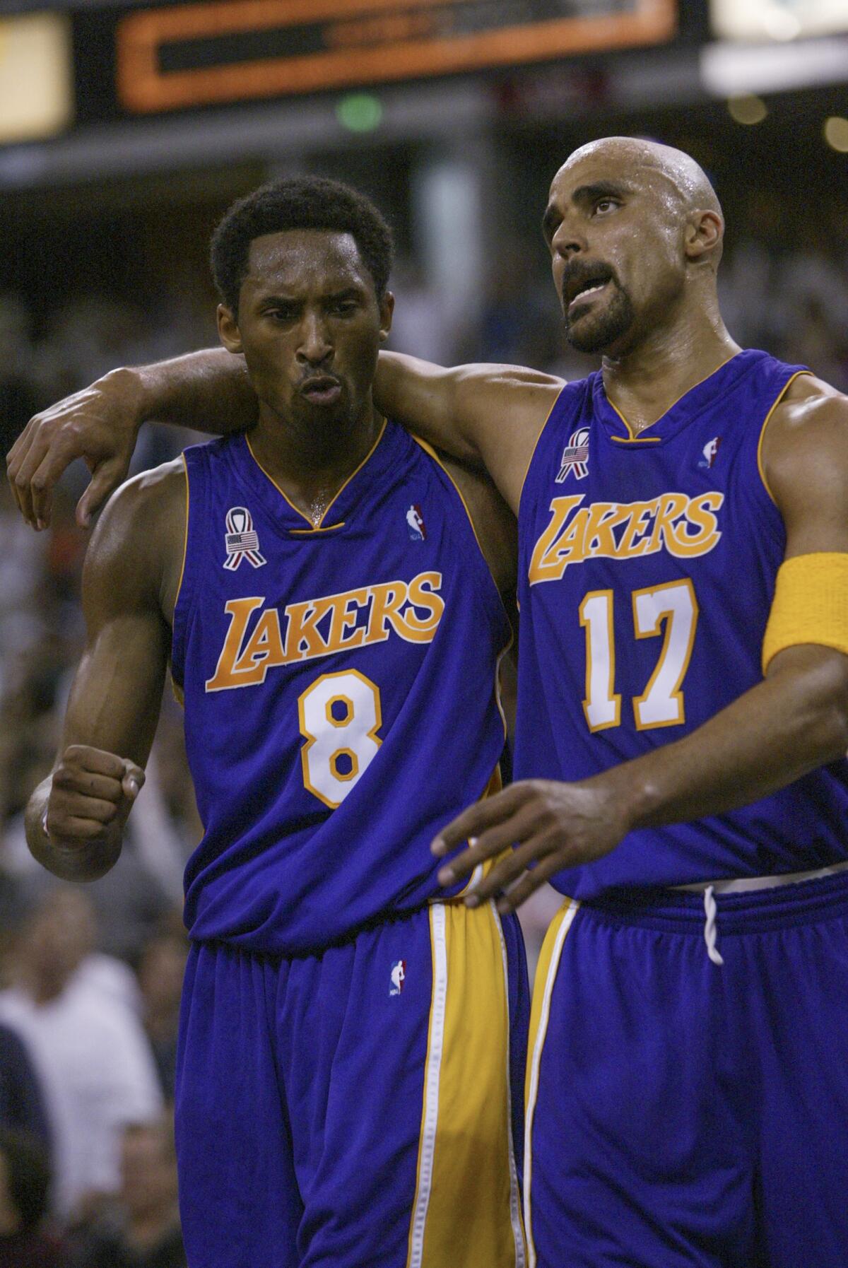 Kobe Bryant and Rick Fox embrace during a break in a game against the Sacramento Kings in 2002.