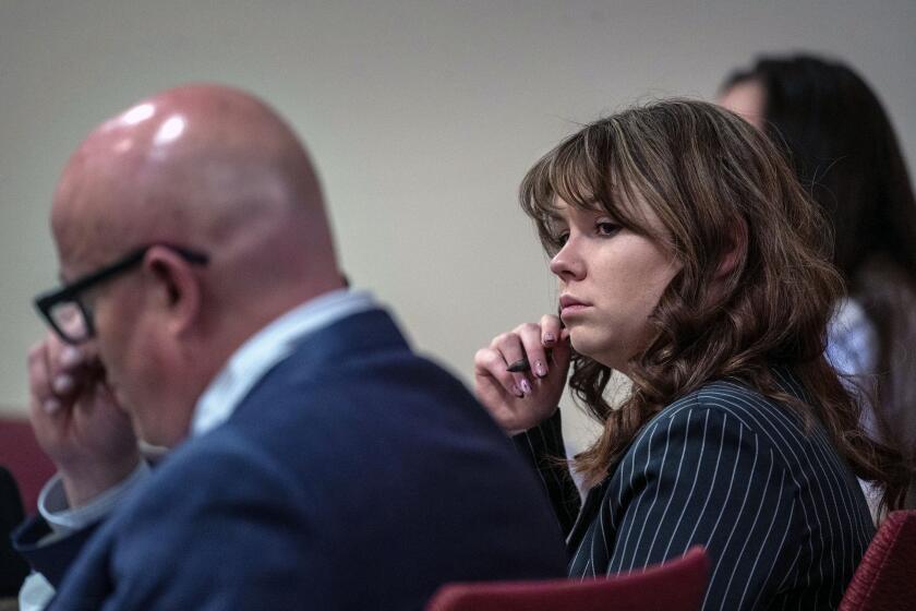 Hannah Gutierrez-Reed, center, sits with her attorney Jason Bowles, left, during testimony in the trial against her in First District Court, in Santa Fe, N.M., Friday, March, 1, 2024. Gutierrez-Reed was working as the armorer on the movie "Rust" when actor Alec Baldwin fatally shot cinematographer Halyna Hutchins and wounded Souza. Gutierrez-Reed is fighting involuntary manslaughter and tampering with evidence charges.(Eddie Moore/The Albuquerque Journal via AP, Pool)