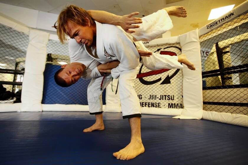 Actor Sean Patrick Flanery, standing, practices jiujitsu with Henry Akins at his gym, Dynamix.