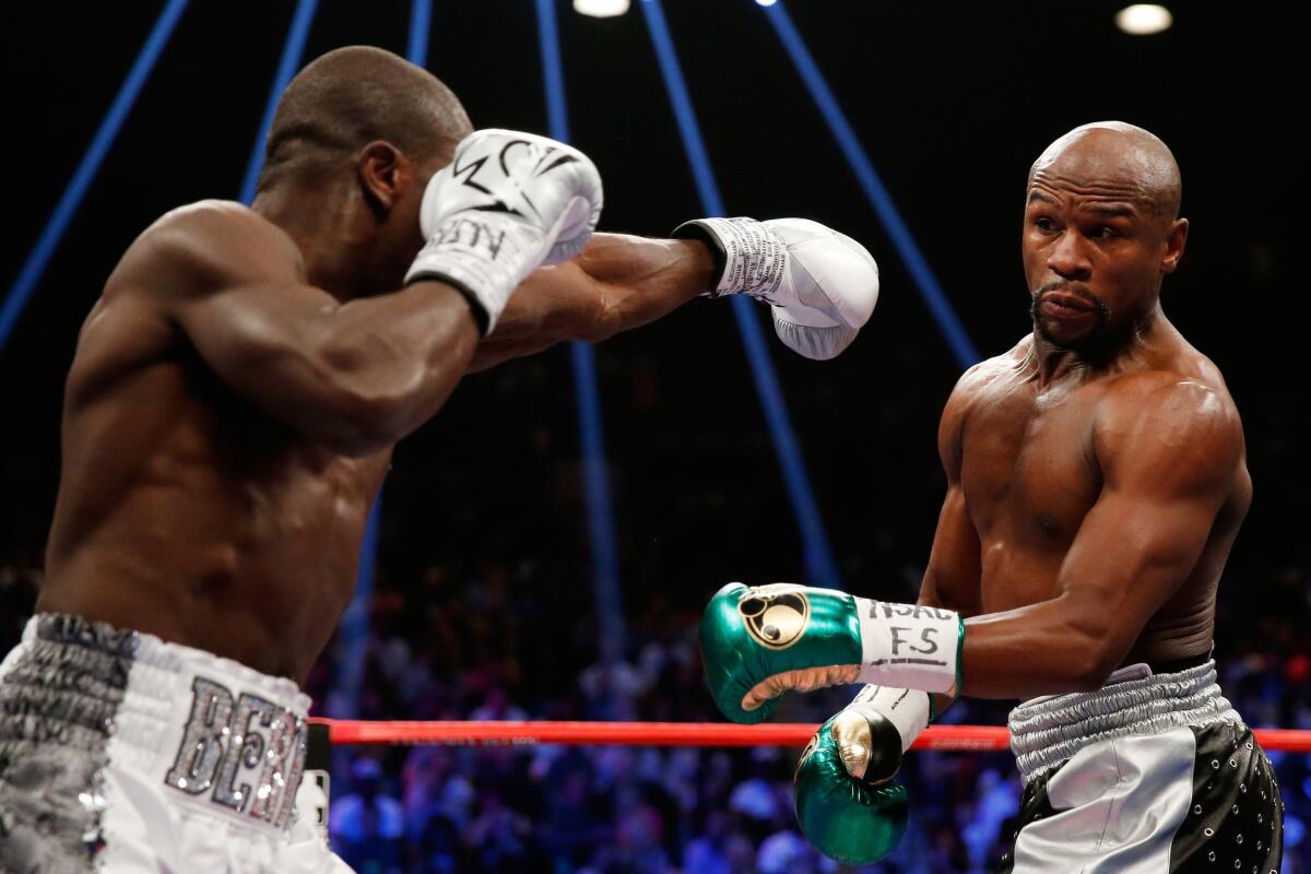 Floyd Mayweather Jr. dodges a left from Andre Berto during their WBC/WBA welterweight title fight at MGM Grand Garden Arena.