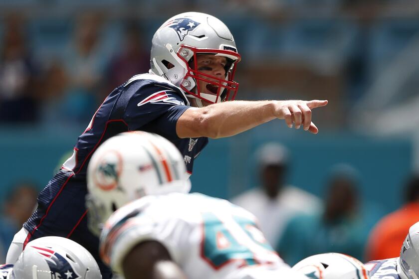 MIAMI, FLORIDA - SEPTEMBER 15: Tom Brady #12 of the New England Patriots calls a play prior to the snap against the Miami Dolphins during the first quarter in the game at Hard Rock Stadium on September 15, 2019 in Miami, Florida. (Photo by Michael Reaves/Getty Images)