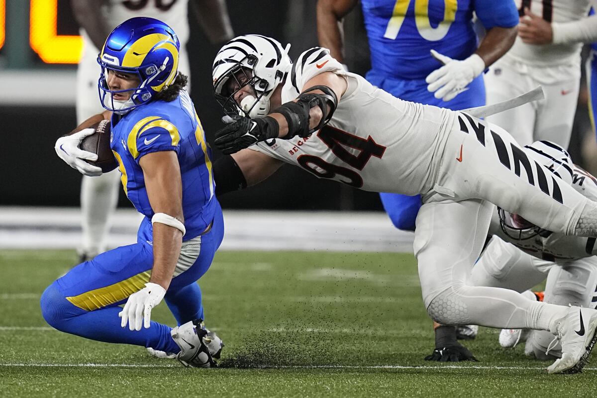 Rams wide receiver Puka Nacua, left, is tackled by Cincinnati Bengals defensive end Sam Hubbard in the first half.