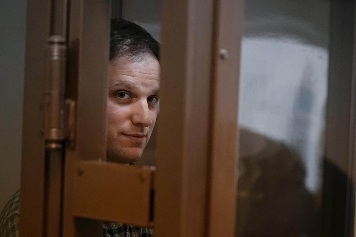 FILE - Wall Street Journal reporter Evan Gershkovich stands in a glass cage in a courtroom in Moscow, Russia, on April 18, 2023. Gershkovich, a U.S. citizen, was arrested in March on espionage charges, which he has denied, as have his employer and the U.S. government. (AP Photo/Alexander Zemlianichenko, File)