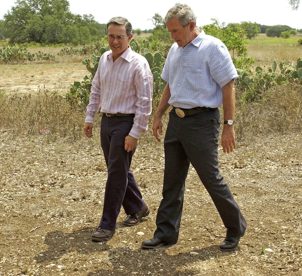 Colombian President Alvaro Uribe and President George W. Bush after their joint news conference at Bush's Prairie Chapel Ranch in August 2005.