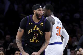 Los Angeles, CA - December 18: Lakers forward Anthony Davis, #3, left, celebrates his fourth.