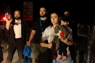 Families are evacuated by the United Nations at the buffer zone in Syria's southern Daraa province.