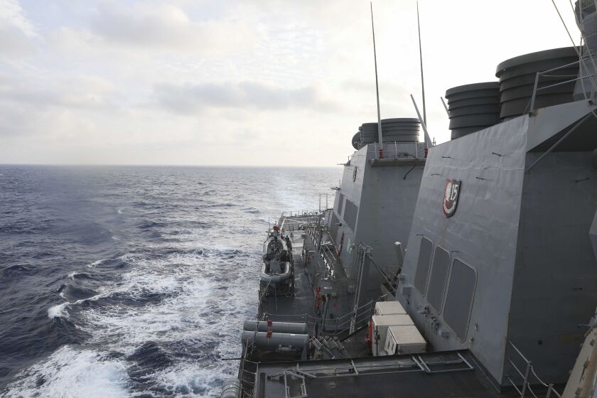 In this photo provided by the U.S. Navy, the Arleigh Burke-class guided-missile destroyer USS Milius (DDG 69) conducts routine underway operations in South China Sea, Friday March 24, 2023. China threatened “serious consequences” Friday, after the U.S. Navy sailed a destroyer around the disputed Paracel Islands in the South China Sea the second day in a row, which Beijing claimed was a violation of its sovereignty and security.(Mass Communication Specialist 1st Class Greg Johnson/U.S. Navy via AP)