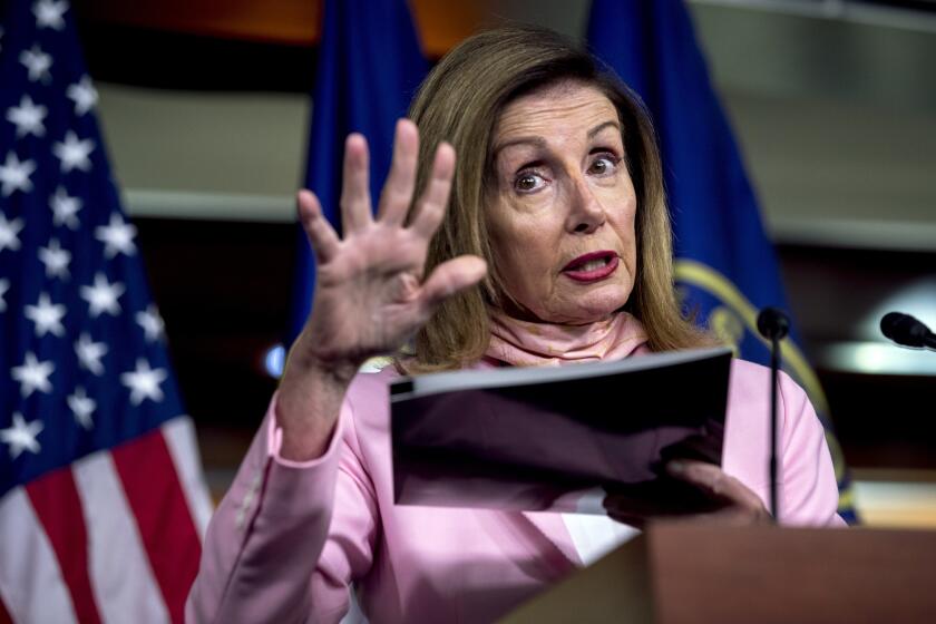 House Speaker Nancy Pelosi of Calif. uses a folder as a prop as she speaks about mail in voting during a news conference on Capitol Hill in Washington, Friday, July 31, 2020. (AP Photo/Andrew Harnik)