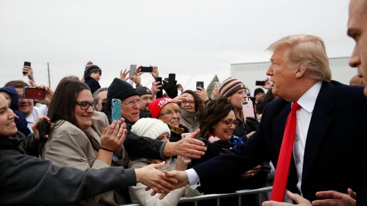 President Trump greets supporters on arriving in New Orleans on Monday to address the American Farm Bureau Federation.