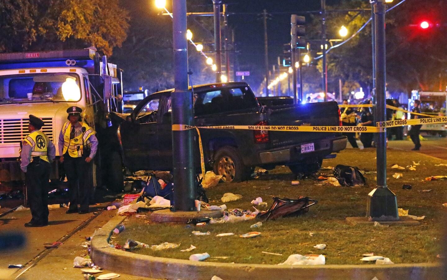 Police stand next to a pickup truck that slammed into a crowd and other vehicles, causing multiple injuries, during the Krewe of Endymion parade in New Orleans on Feb. 25, 2017.
