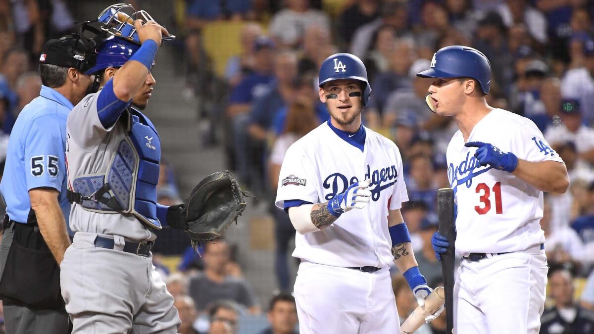 Dodgers Joc Pederson argues with umpire Angel Hernandez on a strikeout as Yasmandi Grandal tries to intervene.
