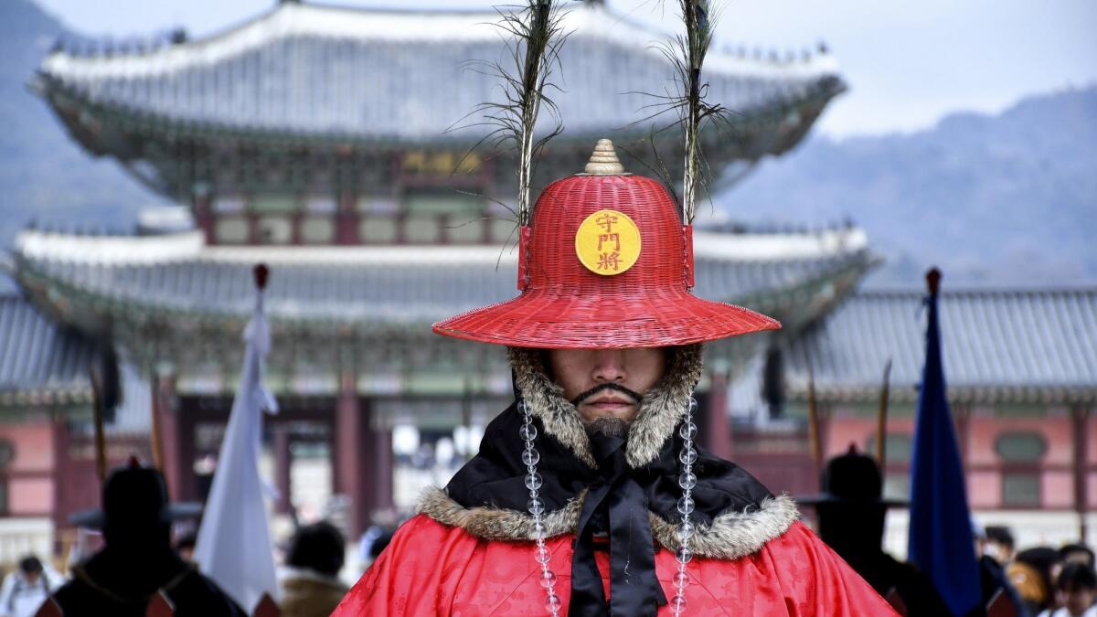 Twice daily, crowds gather for the changing of the guard at Gwanghwamun Gate of Gyeongbokgung Palace, Seoul. If that mustache looks fake, it's because it is. The guards are actors