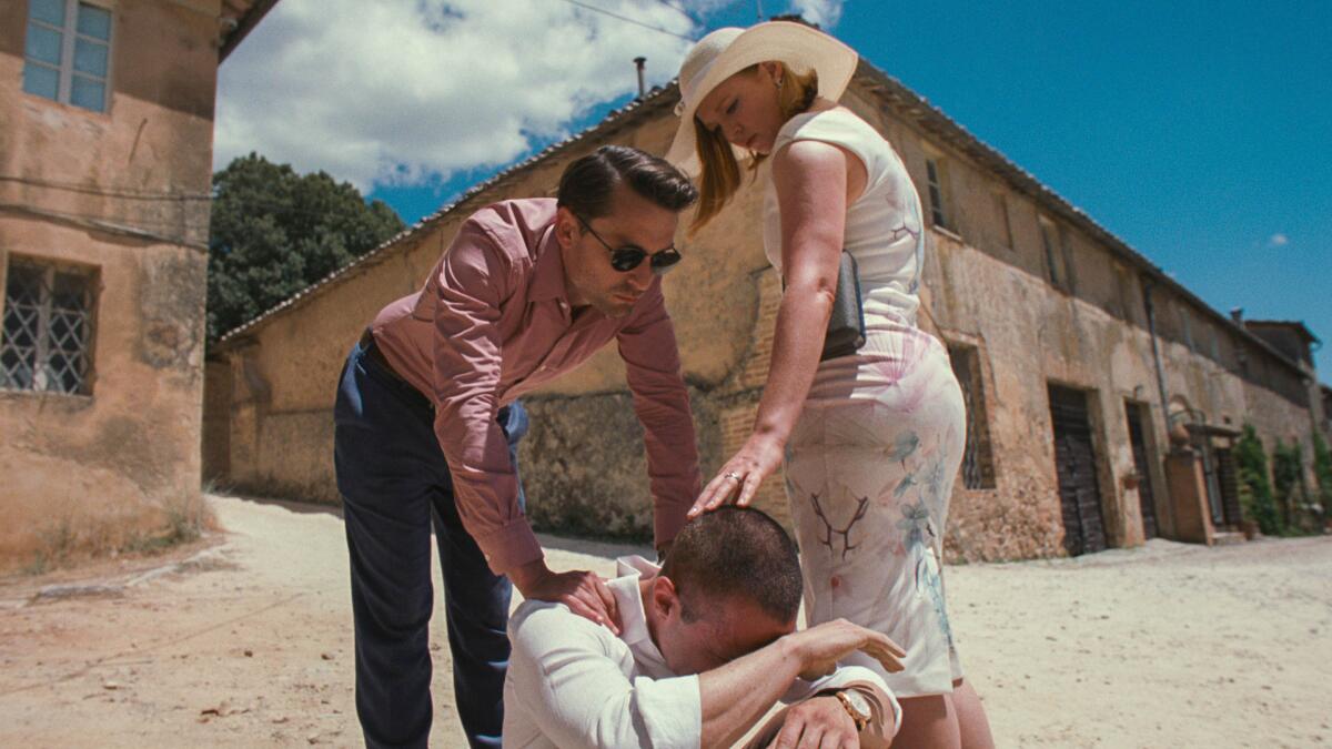 Three people posed under the sun.