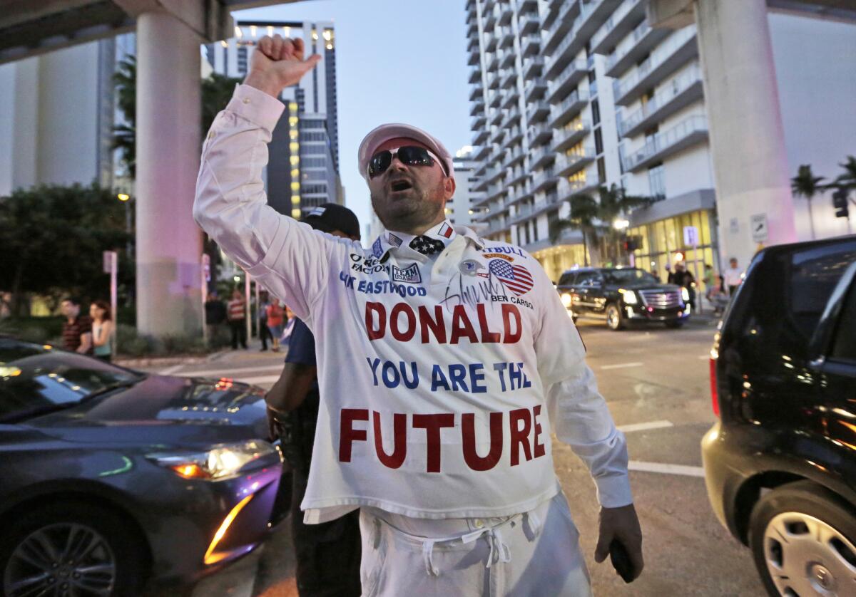 Janusz Biskupek of Boca Raton, Fla., a supporter of Republican presidential candidate Donald Trump, shouts Friday at protesters outside a campaign rally attended by Trump in Miami.