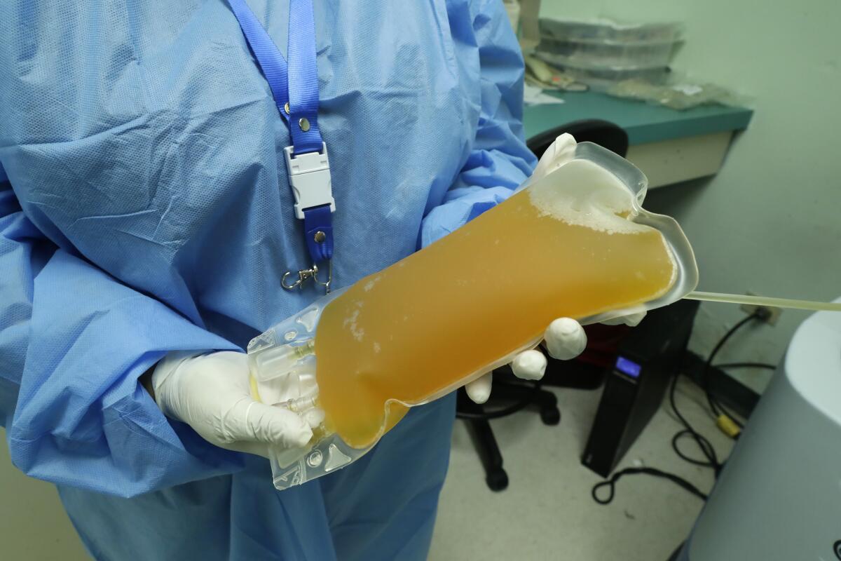 A doctor in Panama City holds a donation of convalescent blood plasma from a recovered COVID-19 patient. Scientists hope antibodies in the plasma will help people who are critically ill from the coronavirus.