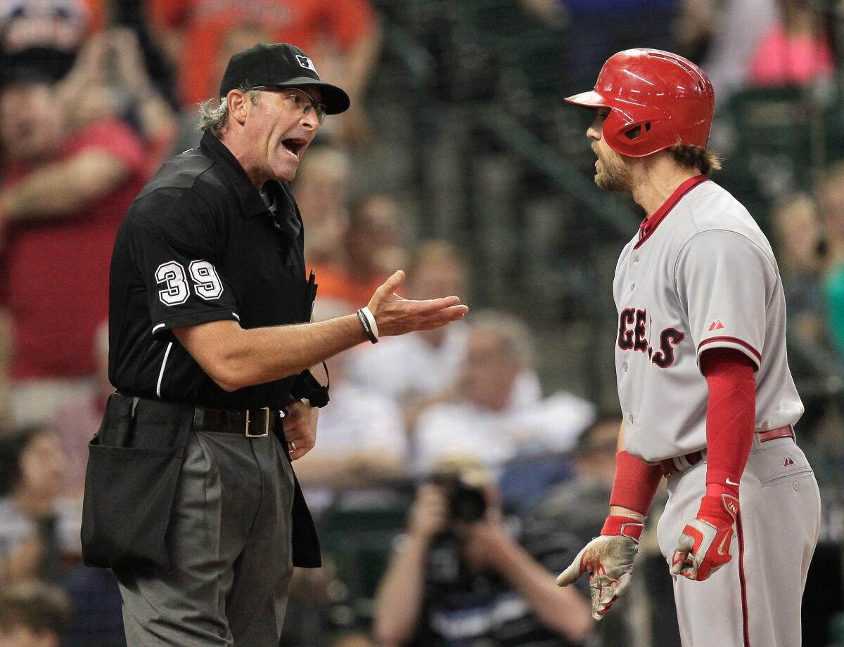 Angels left fielder Collin Cowgill argues with home plate umpire Paul Nauert after being ejected in the seventh inning. The Angels lost to the Astros, 4-0.