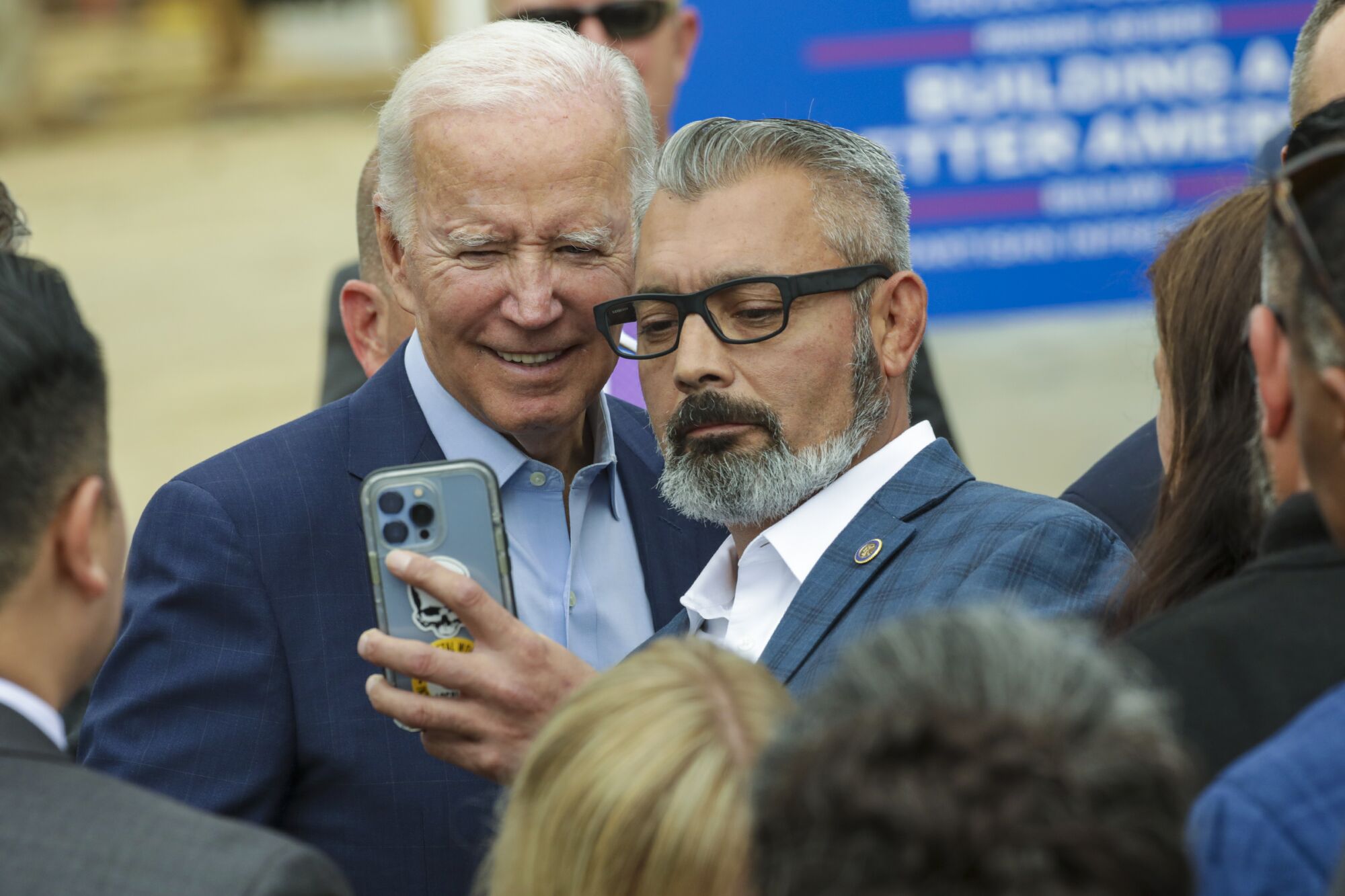 Guests get their selfie with President Joe Biden after visiting the construction site