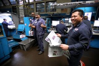 LOS ANGELES, CA - MARCH 8, 2024 - - Ink setter Enrique Romero, 50, gives two thumbs up while color setter David Oma, 51, right, and others look on as a fellow pressman, off camera, leaves work for the last time at the Los Angeles Times Olympic Printing Plant in Los Angeles on March 8, 2024. Oma has worked at the plant for 26 years. (Genaro Molina/Los Angeles Times)