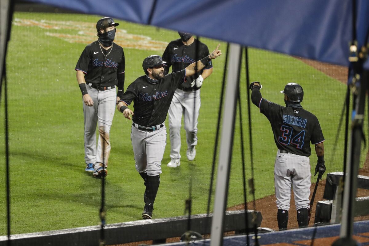 Miami Marlins' Francisco Cervelli celebrates with teammates after hitting a three-run home run during the second inning of a baseball game against the New York Mets Friday, Aug. 7, 2020, in New York. (AP Photo/Frank Franklin II)