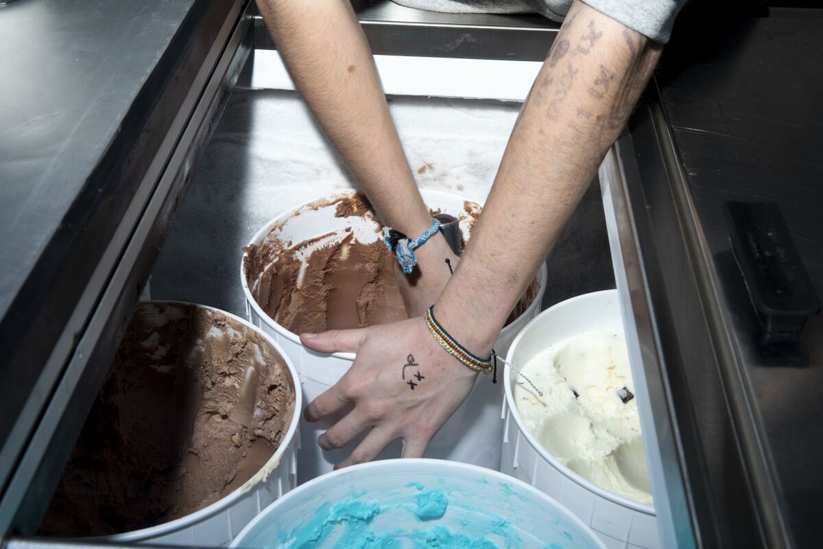 Ella Wynn, 17, scoops ice cream in her family's Wynston's Ice Cream Co. on Tuesday in San Marcos.