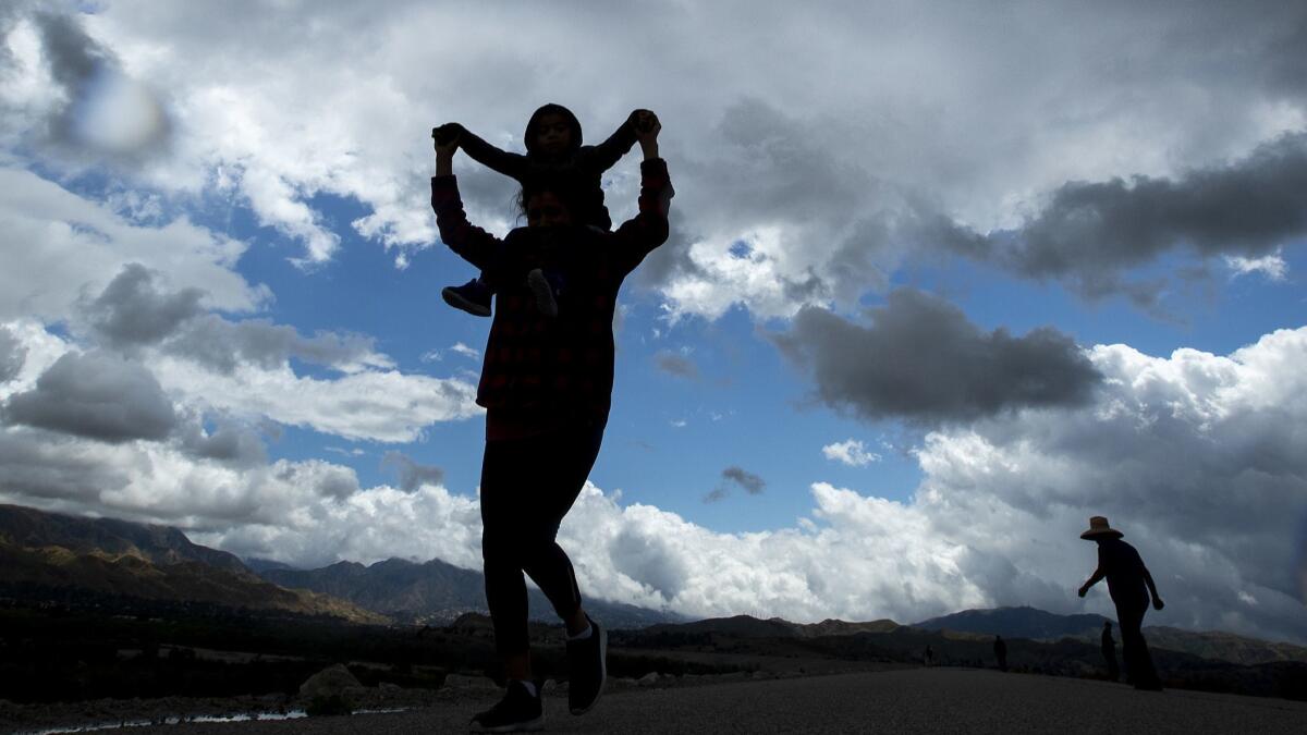 A woman and her 3-year-old son visit the Hansen Dam Recreation Area in Lake View Terrace as rain gave way to partial clouds on May 16.