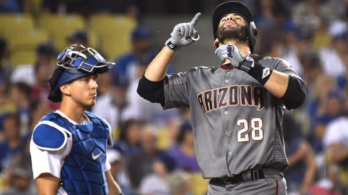 LOS ANGELES, CA - MARCH 31: Los Angeles Dodgers left fielder J.D. Martinez  (28) holds his bat in the dugout during a regular season game between the  Arizona Diamondbacks and Los Angeles