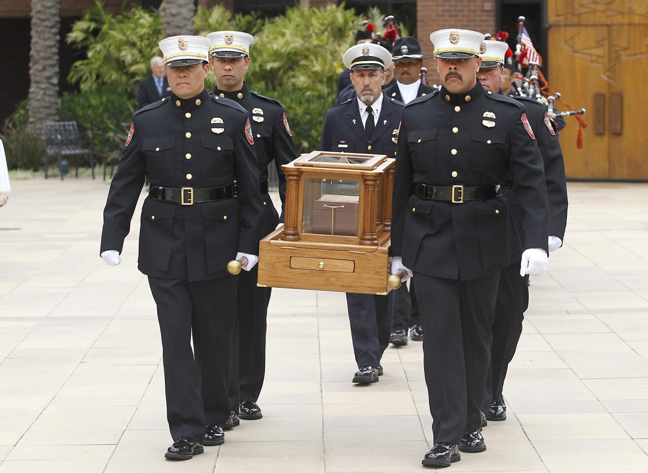 Members of the Anaheim Fire Depatment's Search and Rescue team carry the remains of Grant McKee, 21, for his memorial service in the St. Andrew's Presbyterian Church sanctuary, Saturday. McKee grew up in Costa Mesa and was one of 19 members of the Granite Mountain Hotshot firefighting crew killed in fast moving wildfire in Prescott, Ariz.