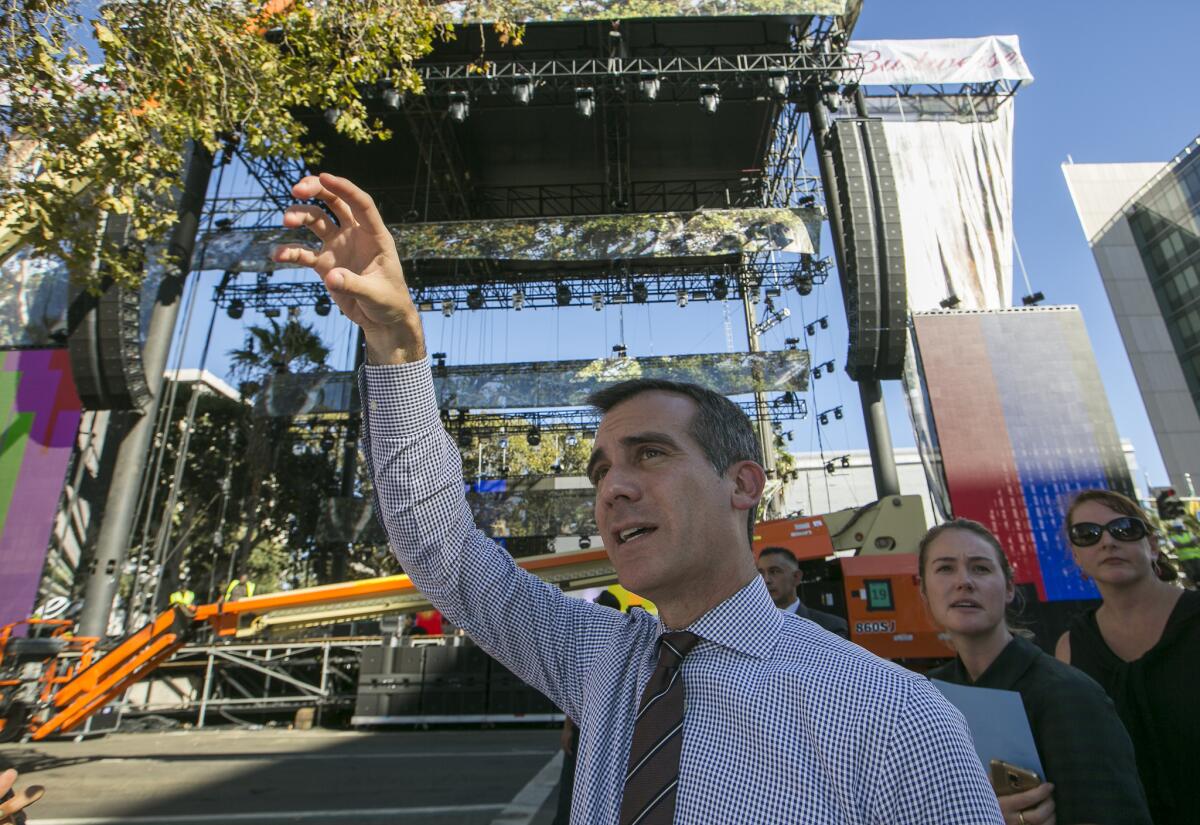 Los Angeles Mayor Eric Garcetti tours the construction of stages for the Made in America Festival in downtown Los Angeles on Thursday.