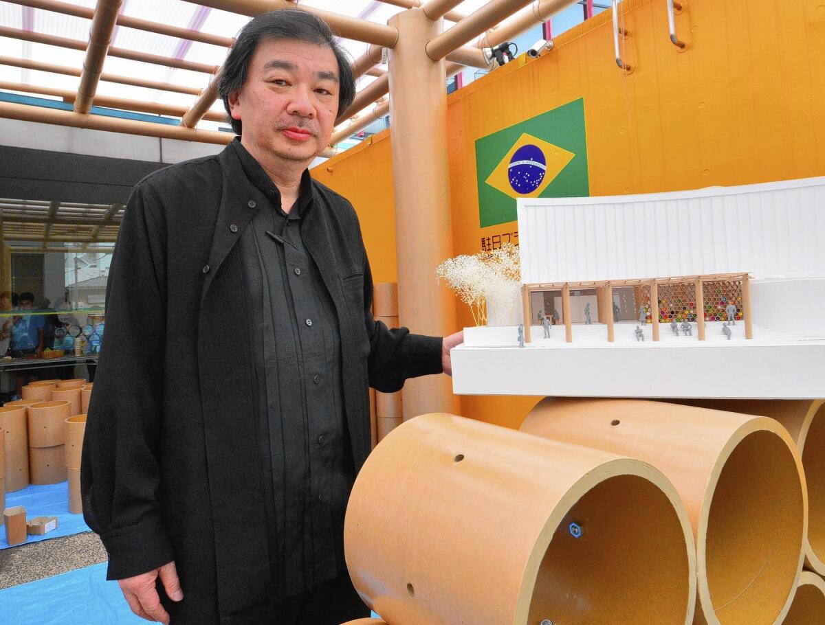 Japan's 2014 Pritzker Architecture Prize winner Shigeru Ban displays a scale model of his designed pavilion built in the grounds of the Brazilian embassy in Tokyo for the FIFA World Cup in Brazil on June 10, 2014.