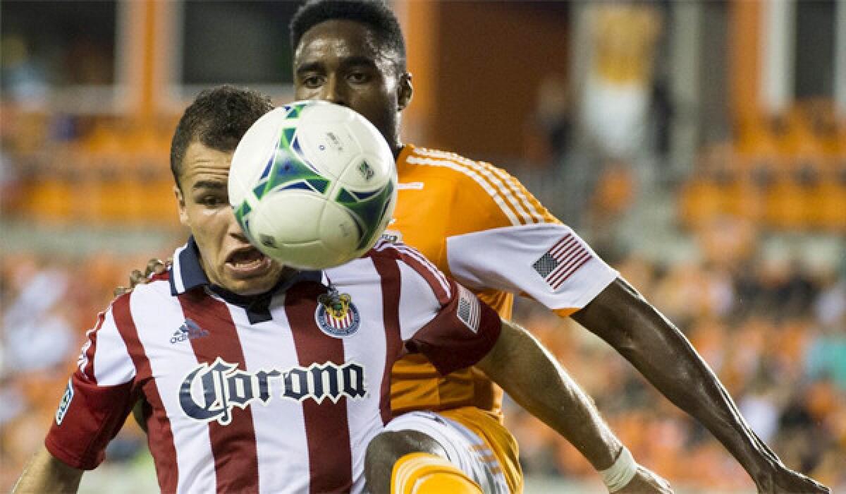 Midfielder Carlos Alvarez gets in front of Houston defender Warren Creavalle to get control of the ball during Chivas USA's loss to the Dynamo, 5-1, on Sept. 21, 2013.