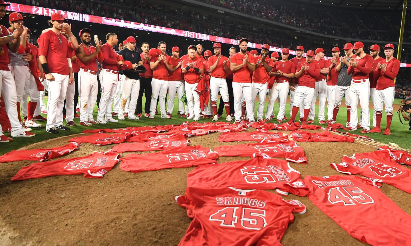 Angel players place their Tyler Skaggs jerseys at the pitchers mound after no-hitting the Mariners.