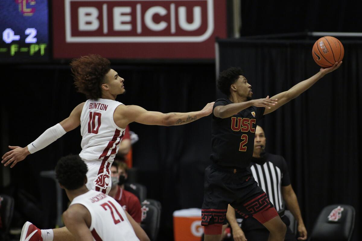 USC's Tahj Eaddy goes up for a shot as Washington State's Isaac Bonton defends Feb. 13, 2021.