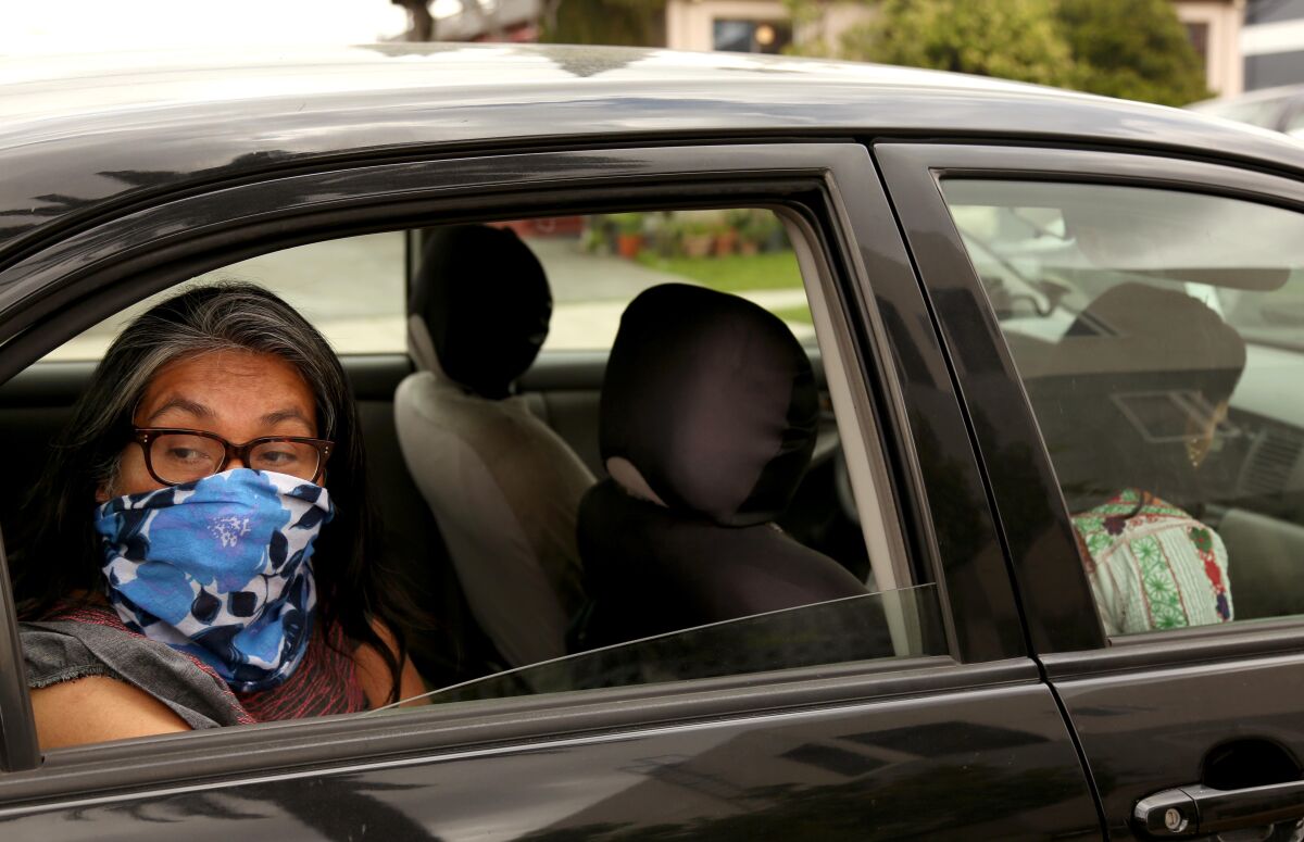 Odilia Romero, left, and Janet Martinez, with CIELO, prepare to drop off relief checks to indigenous people from Mexico and Guatemala in Los Angeles who have lost employment due to the coronavirus.