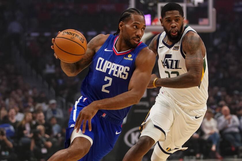 LOS ANGELES, CALIF. - NOVEMBER 03: LA Clippers forward Kawhi Leonard (2) drives to the basket while being chased by Utah Jazz forward Royce O'Neale (23) during a NBA game between the Utah Jazz and the LA Clippers at Staples Center on Sunday, Nov. 3, 2019 in Los Angeles, Calif. (Kent Nishimura / Los Angeles Times)