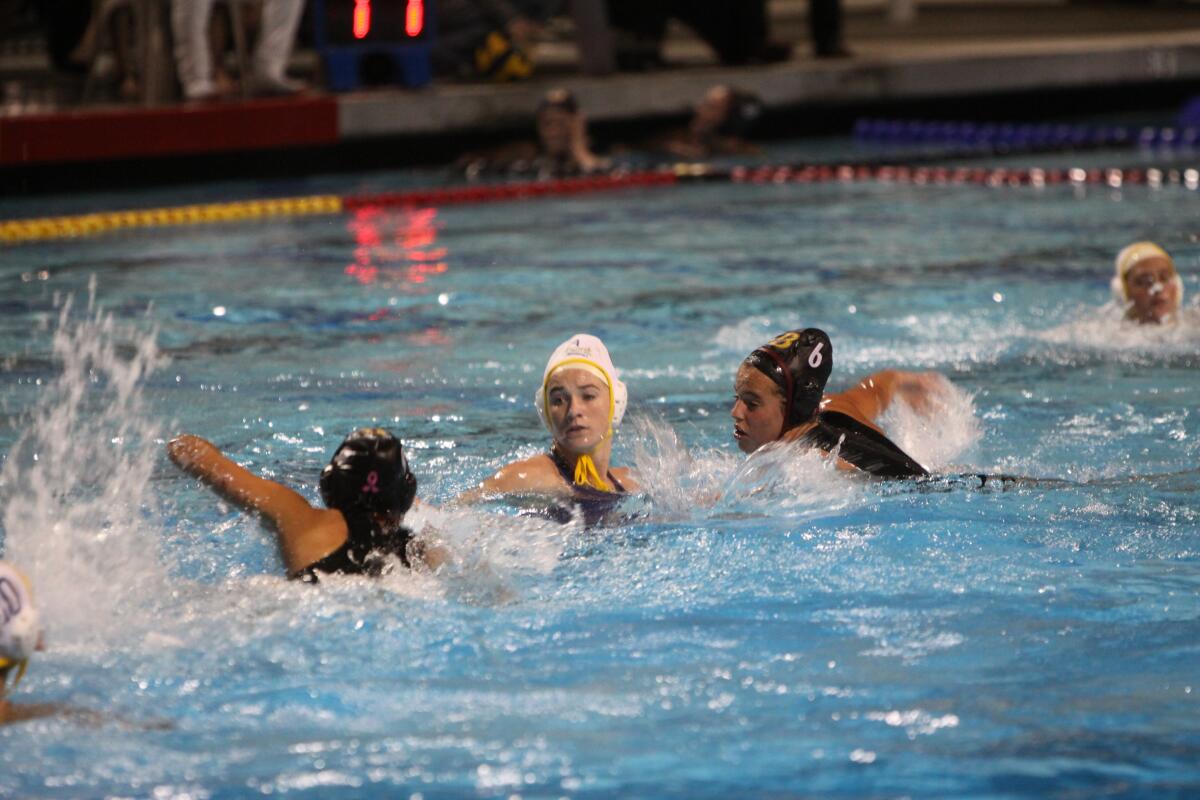 Maggie Johnson (6) contributed to the Knights’ stifling water polo defense.