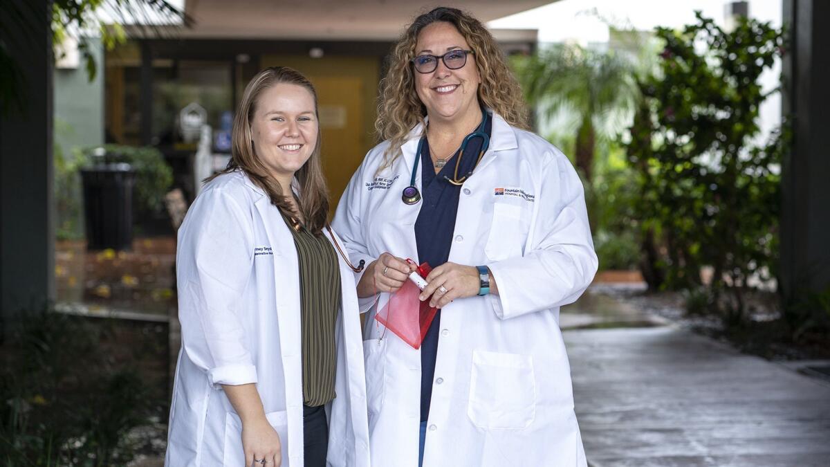 Courtney Snyder, left, and Lisa Ann Behrend, nurses at Fountain Valley Regional Hospital and Medical Center, started handing out Vials of Love in November to families of dying patients.