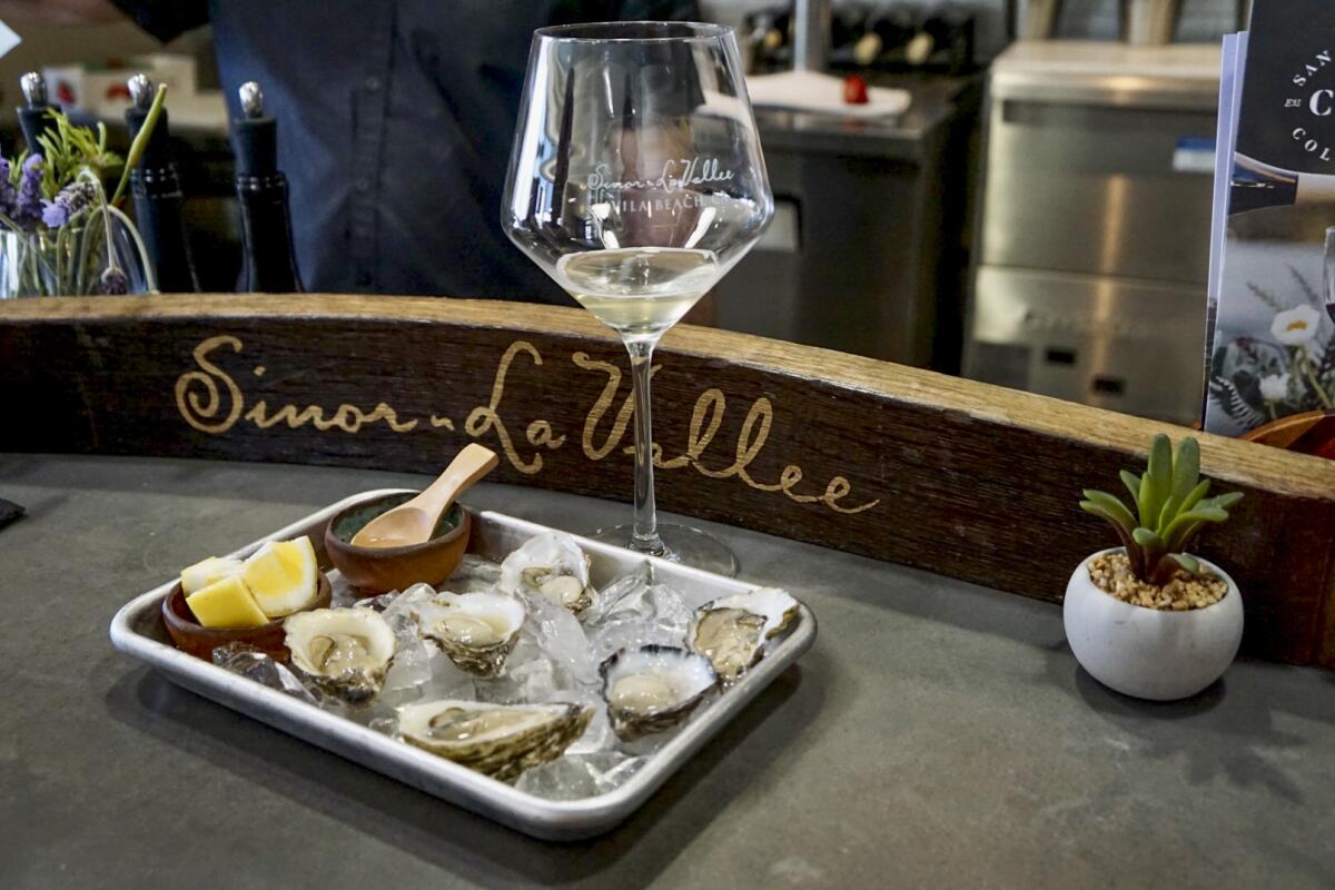 Oysters on a rectangular tray with a wine glass