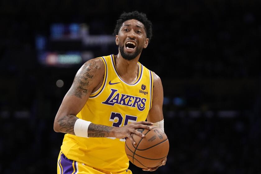 Los Angeles Lakers forward Christian Wood gets set to pass during the first half of an NBA basketball game against the Phoenix Suns Thursday, Oct. 26, 2023, in Los Angeles. (AP Photo/Mark J. Terrill)