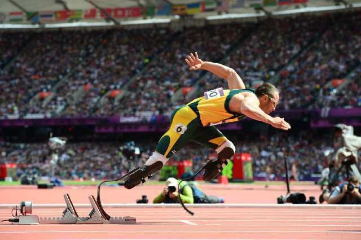 Oscar Pistorius of South Africa leaves the starting blocks on the way to the history books in a men's 400-meter preliminary Saturday.