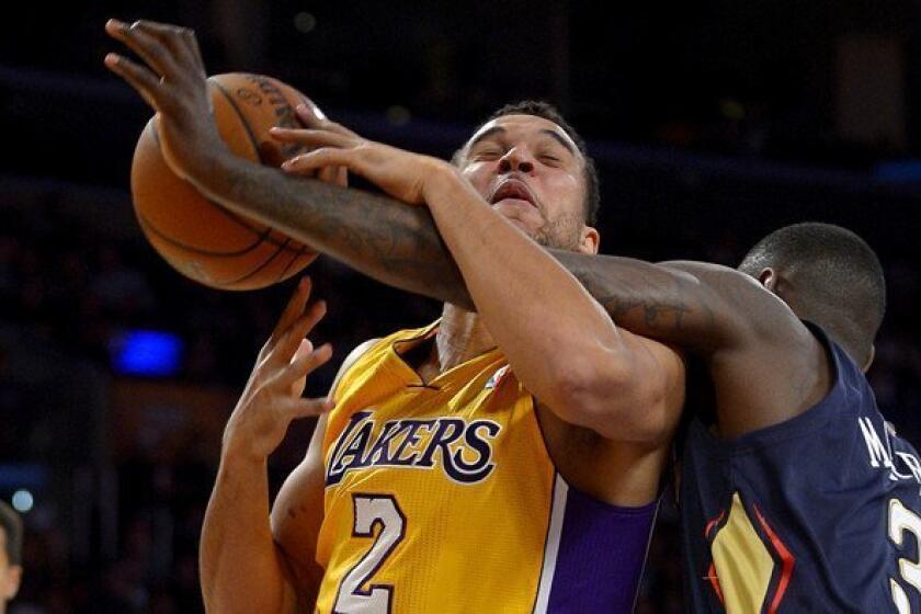 Lakers forward Elias Harris is fouled by New Orleans Pelicans guard Anthony Morrow during a game at Staples Center.