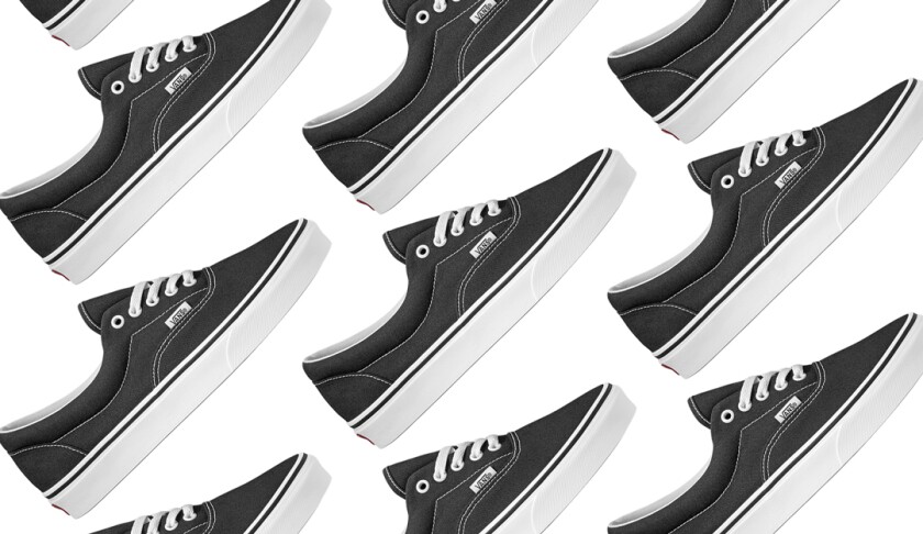 A photo of a black lace-up sneaker with white stitching.