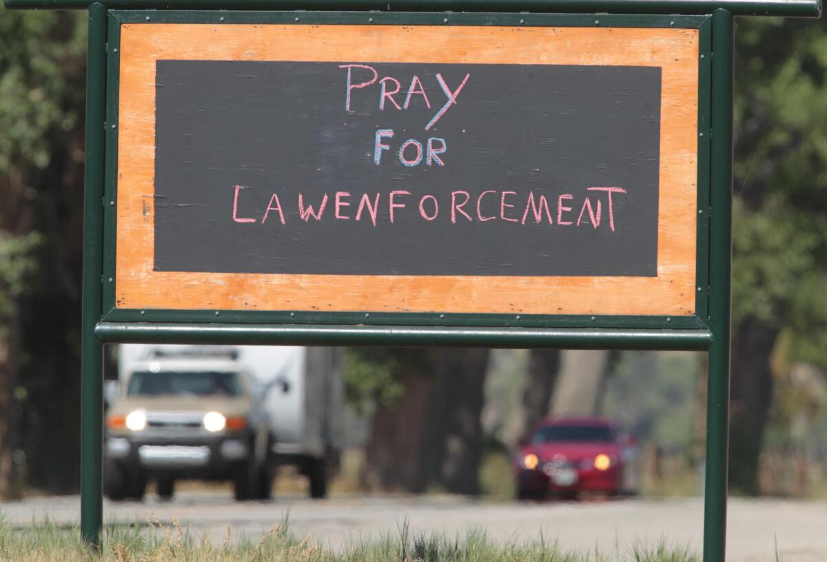 A sign supporting law enforcement is visible to motorists near the Weldon Methodist Church off Highway 178 during the manhunt.